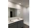 A modern bathroom features a double vanity and a glass-enclosed shower at 511 Coronado Cove Rd, New Smyrna Beach, FL 32168