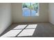 Bright bedroom with plush carpeting and a large window providing natural light at 512 Coronado Cove Rd, New Smyrna Beach, FL 32168