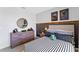 Modern bedroom featuring sporty décor, a dark accent wall, a striped duvet, and stylish furnishings at 514 Coronado Cove Rd, New Smyrna Beach, FL 32168