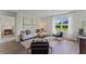 Bright living room featuring modern decor, large windows, and hardwood floors at 514 Coronado Cove Rd, New Smyrna Beach, FL 32168