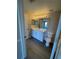 Bathroom features a bright vanity with lighting and a modern toilet at 5578 Metrowest Blvd # 305, Orlando, FL 32811