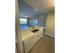 Modern kitchen features white cabinets, quartz countertops, stainless sink and appliances, and open floor plan at 5578 Metrowest Blvd # 305, Orlando, FL 32811