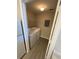 Bright laundry room features a modern washer and dryer and a convenient wire shelf at 5578 Metrowest Blvd # 305, Orlando, FL 32811
