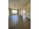 Spacious living room with high ceilings, large window, and modern floors at 5578 Metrowest Blvd # 305, Orlando, FL 32811