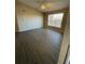 Spacious living room featuring modern flooring, large window, and ceiling fan at 5578 Metrowest Blvd # 305, Orlando, FL 32811