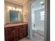 Bathroom with dark wood vanity and sink, next to a white tiled tub and shower combo at 620 E Church St, Orlando, FL 32801