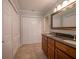 Bathroom featuring a double vanity with granite countertop and tile flooring and large closet at 620 E Church St, Orlando, FL 32801