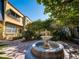 Beautiful courtyard featuring a decorative fountain, mature trees, and elegant stone tiling at 620 E Church St, Orlando, FL 32801