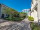 Landscaped courtyard view features paver walk ways, mature trees, and a high rise condo building at 620 E Church St, Orlando, FL 32801