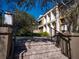 Beautiful townhome exterior with a stone stairway, iron railings, and manicured landscaping at 620 E Church St, Orlando, FL 32801