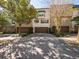Row of garages with mature trees and landscaping along the driveways at 620 E Church St, Orlando, FL 32801