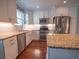 Modern kitchen featuring white cabinets, stainless steel appliances, and granite countertops at 620 E Church St, Orlando, FL 32801