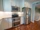 Close-up of a modern kitchen featuring stainless steel appliances and white cabinets at 620 E Church St, Orlando, FL 32801