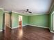 Spacious living room showcasing hardwood floors, fresh green paint, and access to the bath at 620 E Church St, Orlando, FL 32801