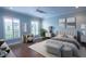 Stylish primary bedroom with ample natural light, plantation shutters, and hardwood floors at 620 E Church St, Orlando, FL 32801