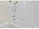 The bathroom has a shower and bathtub combination with white tiled walls at 6613 Duncaster St, Windermere, FL 34786