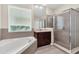 This bathroom showcases a separate shower, soaking tub, and natural light from the window at 6613 Duncaster St, Windermere, FL 34786