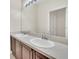 Bathroom features a double sink vanity with a large mirror and neutral color palette at 6613 Duncaster St, Windermere, FL 34786