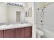 The bathroom showcases a shower and bathtub combination with a double sink vanity at 6613 Duncaster St, Windermere, FL 34786