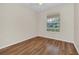 Simple bedroom features hardwood floors, natural light from the window at 6613 Duncaster St, Windermere, FL 34786