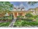 Charming home with a welcoming front porch, dormer windows, and manicured landscaping at 6613 Duncaster St, Windermere, FL 34786