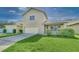 Two-story home with manicured lawn, attached garage, and inviting front porch area at 6613 Duncaster St, Windermere, FL 34786