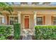 A close-up of the home's front door with columns, hedges, and symmetrical window placement at 6613 Duncaster St, Windermere, FL 34786