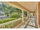 Inviting front porch with white railings and columns offering shade and curb appeal at 6613 Duncaster St, Windermere, FL 34786