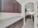 A brightly lit butler's pantry offers generous counter space and storage cabinets at 6613 Duncaster St, Windermere, FL 34786