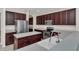 Well-lit kitchen features stainless steel appliances, ample storage space, and center island at 6613 Duncaster St, Windermere, FL 34786