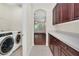 A stylish laundry room connects to the main living area and kitchen with bonus storage at 6613 Duncaster St, Windermere, FL 34786