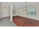 Well-lit living space shows hardwood flooring, large windows, and a neutral color palette at 6613 Duncaster St, Windermere, FL 34786