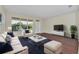 Stylish living room with hardwood floors, contemporary furniture, and abundant natural light at 6613 Duncaster St, Windermere, FL 34786