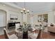 Bright open-concept living area featuring glass table, modern decor, and wood floors at 6613 Duncaster St, Windermere, FL 34786