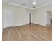 A spacious main bedroom with tray ceiling, hardwood flooring, and multiple doors at 6613 Duncaster St, Windermere, FL 34786