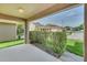 Covered patio view overlooking the landscaped yard and neighborhood street at 6613 Duncaster St, Windermere, FL 34786