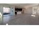Open concept living area featuring tile floors, bright neutral paint, and sliding glass door access at 7020 Rolling Leaf Dr, Groveland, FL 34736