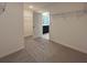 Walk-in closet with metal shelving and neutral carpet flooring near the bathroom at 7020 Rolling Leaf Dr, Groveland, FL 34736