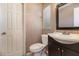Bathroom with toilet, vanity, mirror, and white door in need of renovation at 7906 Rideout Rd, Riverview, FL at 7906 Arabian Pl, Orlando, FL 32818