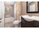 Tiled bathroom featuring a dark vanity and shower over tub at 7906 Arabian Pl, Orlando, FL 32818