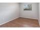 Bedroom featuring neutral walls, wood-look flooring and window at 7906 Arabian Pl, Orlando, FL 32818