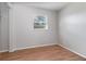 Bedroom featuring neutral walls, wood-look flooring and window at 7906 Arabian Pl, Orlando, FL 32818