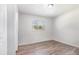 Cozy bedroom with neutral walls, wood-look flooring, and a bright window at 7906 Arabian Pl, Orlando, FL 32818