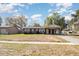Charming single-story home with carport and spacious front yard on a sunny day at 7906 Arabian Pl, Orlando, FL 32818