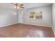Bright living room with wood-look flooring, large windows, and a ceiling fan at 7906 Arabian Pl, Orlando, FL 32818