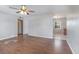 Spacious living room features wood-look flooring and leads into kitchen area at 7906 Arabian Pl, Orlando, FL 32818