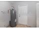Utility room with water heater, door, and concrete block walls at 7906 Rideout Rd, Riverview, FL at 7906 Arabian Pl, Orlando, FL 32818