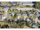 Aerial view of the homes in the neighborhood, showcasing the tree coverage and nearby parking at 823 Kokomo Cir, Port Orange, FL 32127