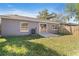 The backyard features lush grass, a patio and a wooden fence for privacy at 823 Kokomo Cir, Port Orange, FL 32127