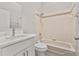 Modern bathroom features white cabinets, quartz countertop, and shower-tub combo at 823 Kokomo Cir, Port Orange, FL 32127